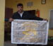 alt="Swadha team with women artisans working on handmade fabric"